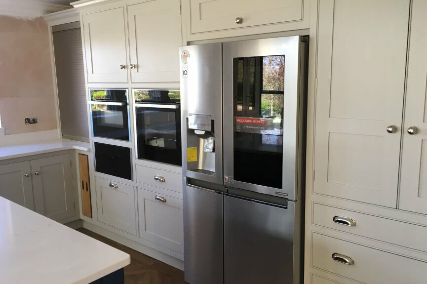 Cream kitchen units with built in Appliances