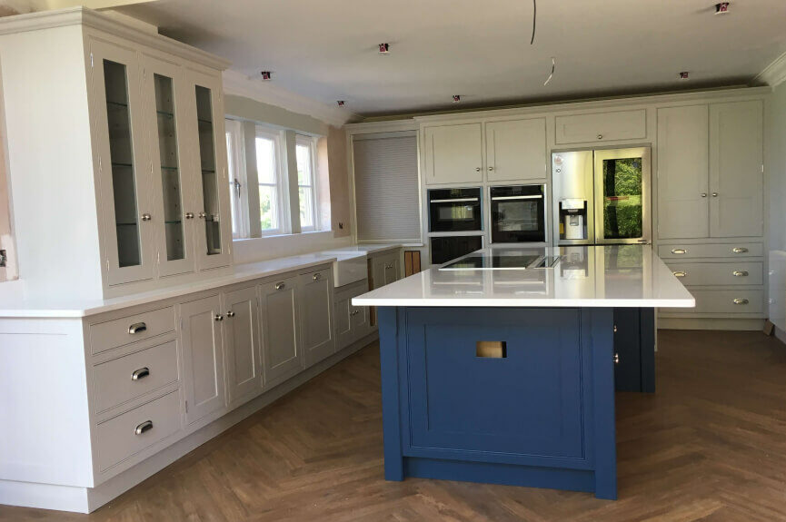 bespoke crean kitchen units with blue central island