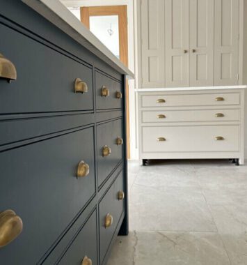 Long Burton Bespoke island worktop with blue cabinets and draws